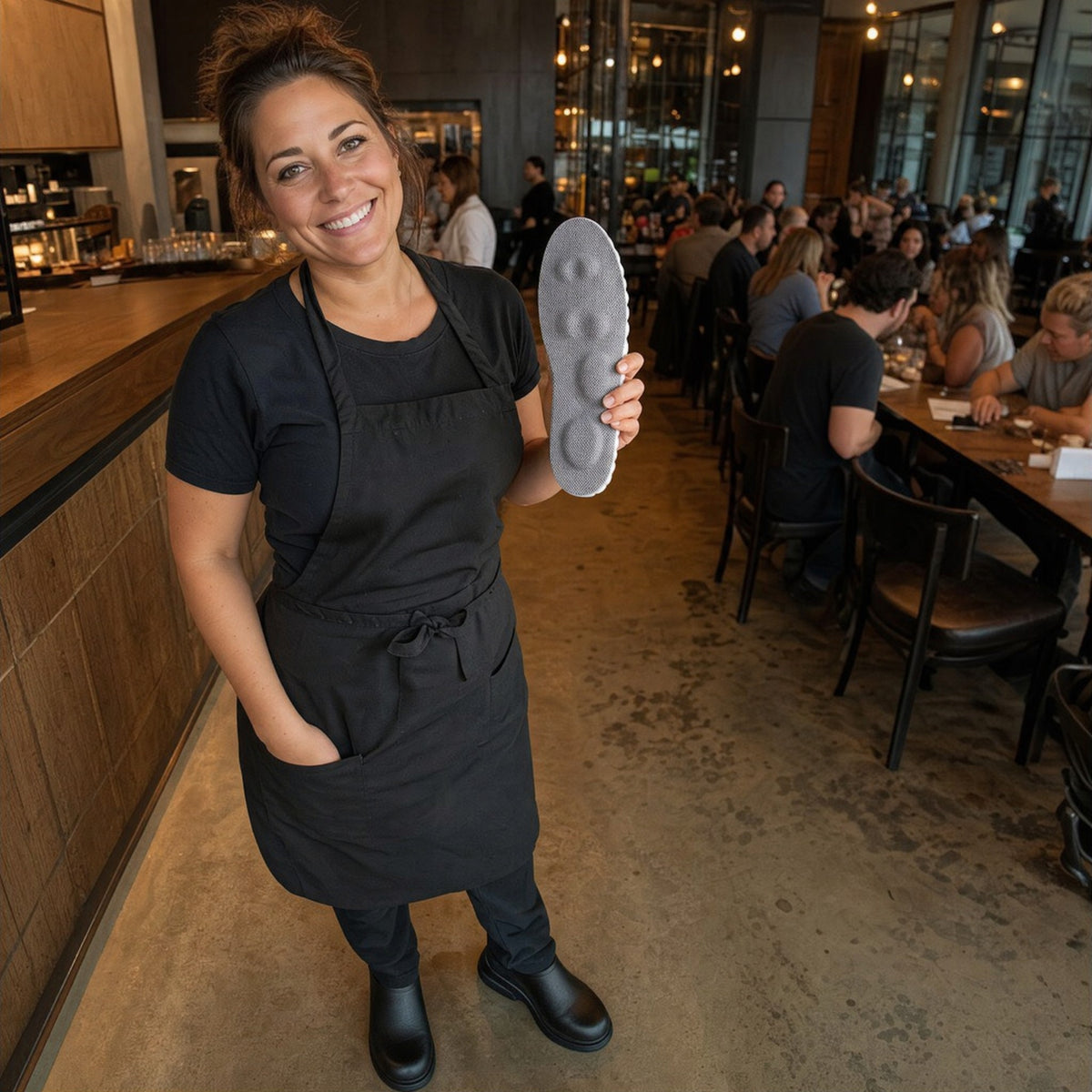 Server holding a NimbleSole insole at the end of her shift